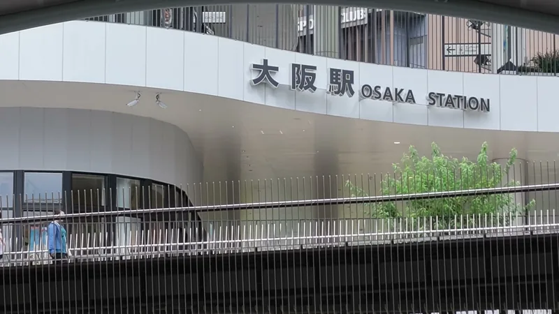 曲面の外壁に掲げられた「大阪駅 OSAKA STATION」のサイン